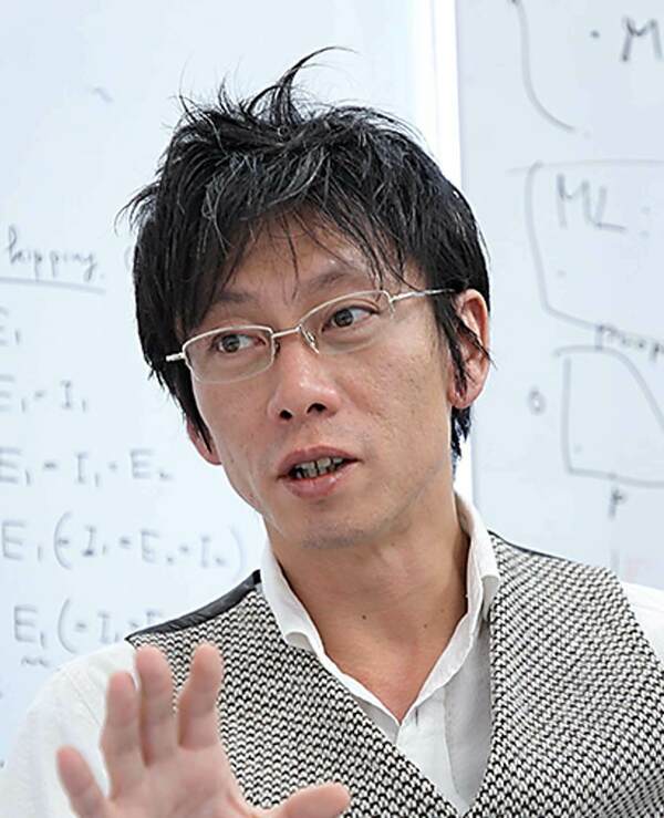 Headshot of Ryo Yoshida. An East Asian man with dark hair and glasses wears a dark coat over a light collared shirt, looking directly at the viewer with a neutral expression.